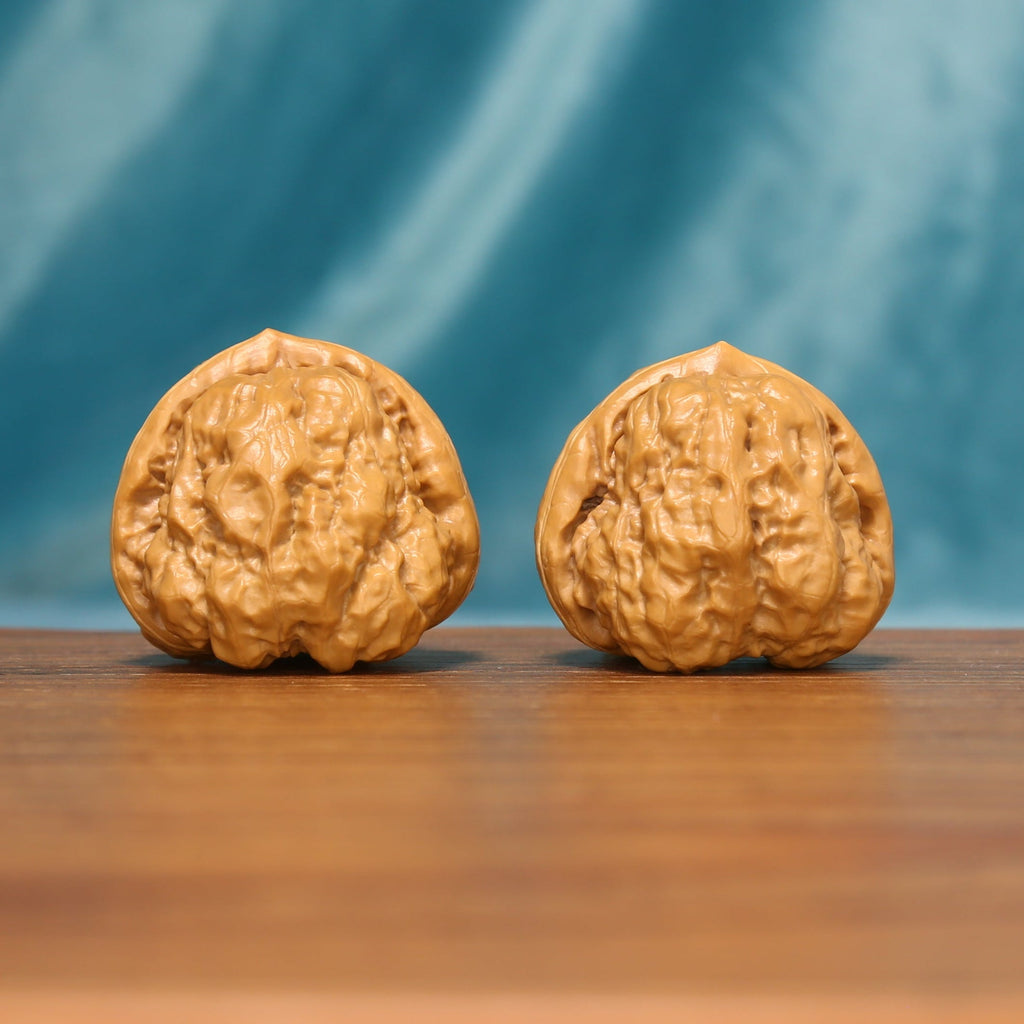 The Azure Rosette L38 wenwan walnut pair standing upright on a wooden surface
