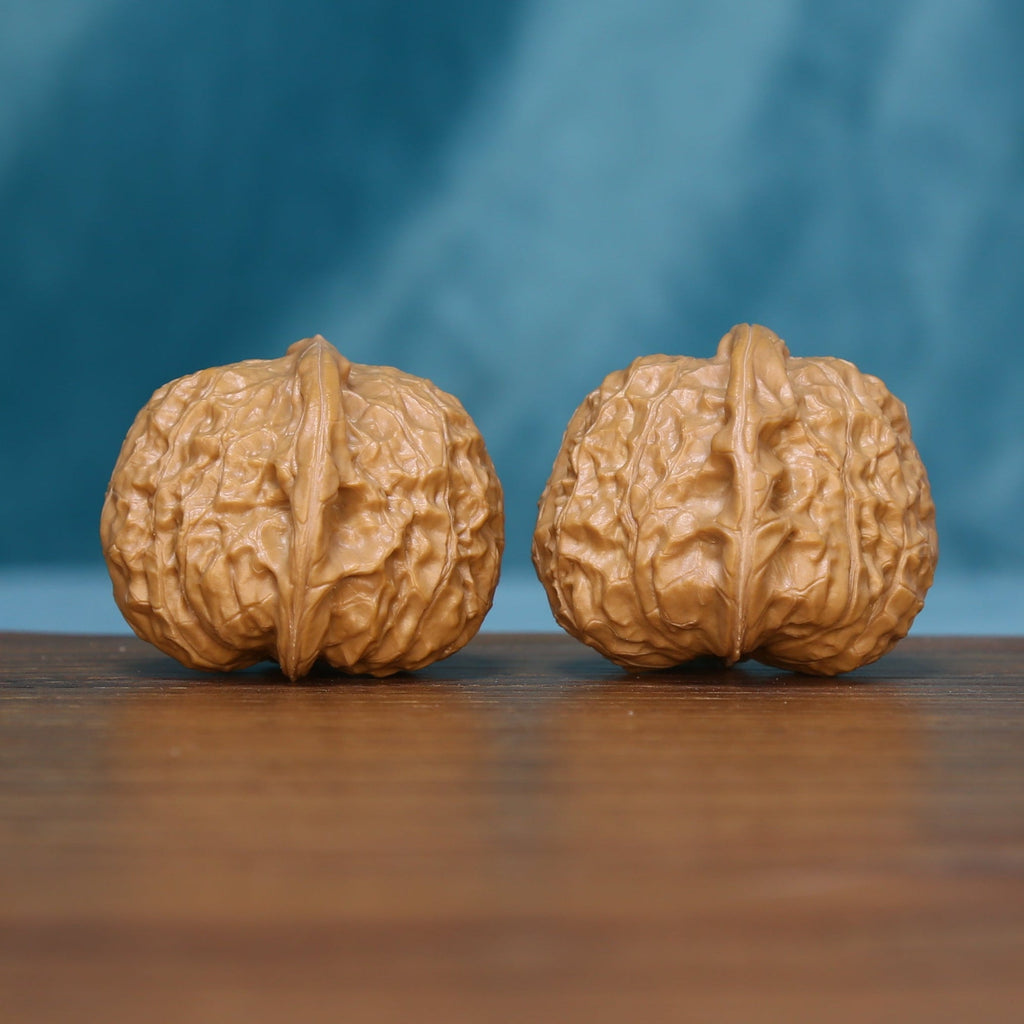 Front view of two 6105 wenwan walnuts with raised branching ridges
