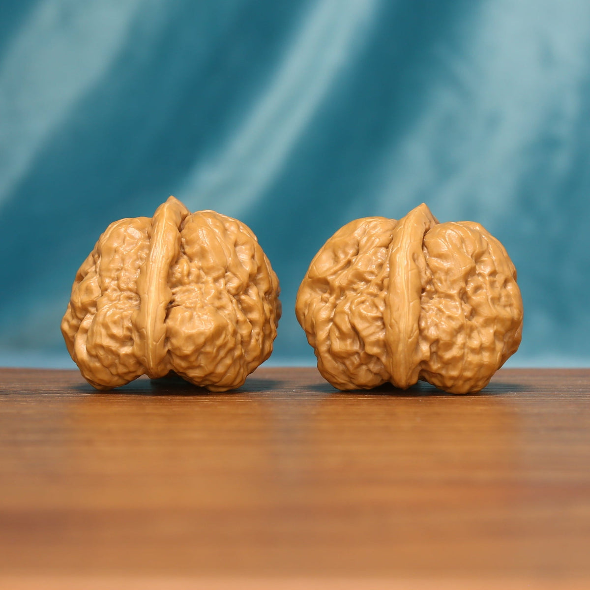 The Azure Rosette L38 wenwan walnut pair showing natural sculpted textures
