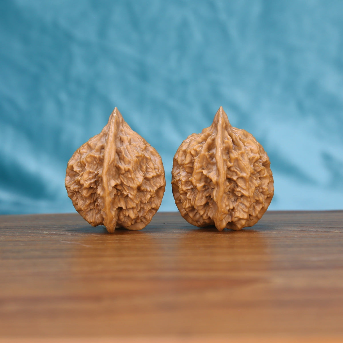  Di-Wang walnut pair bottom view on wood – natural spire base pattern, The Spire premium set