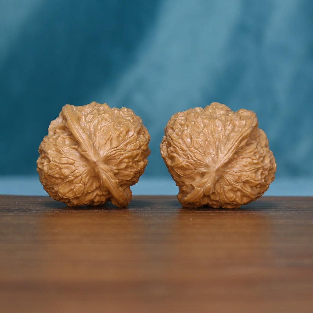 Side view of two 6105 Sunlit Ridge wenwan walnuts showing natural grooves
