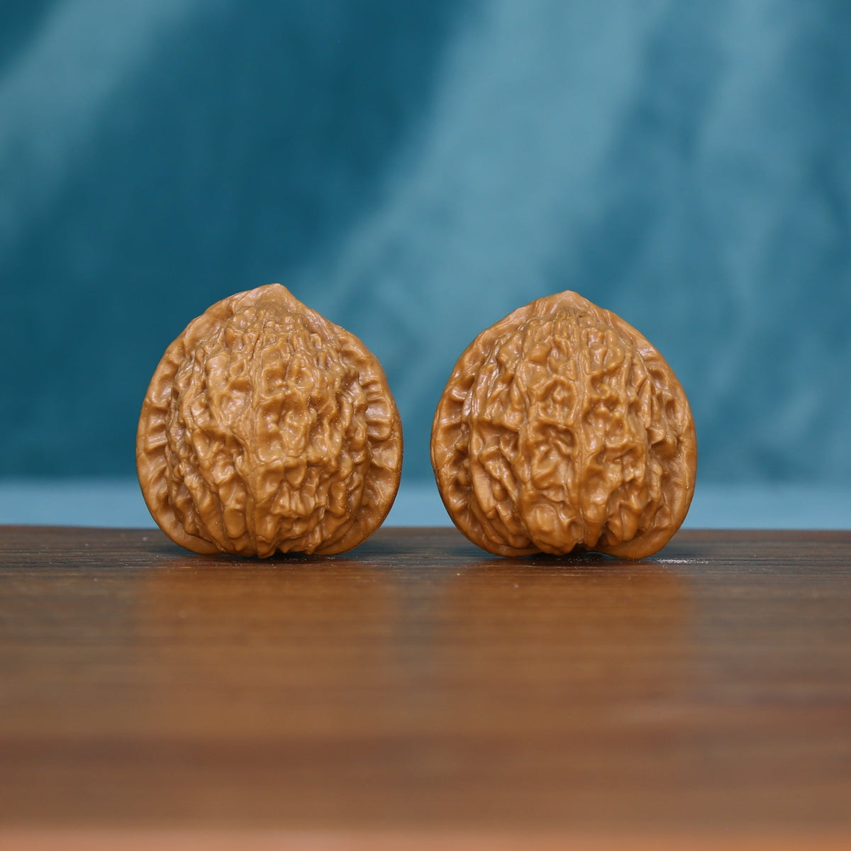 Pair of 5626 wenwan walnuts standing upright with textured tan shells
