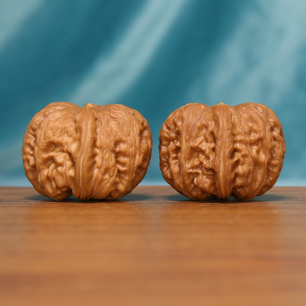 L24 Wenwan walnut matched pair shown from a detailed frontal angle, displaying dense natural ridges.
