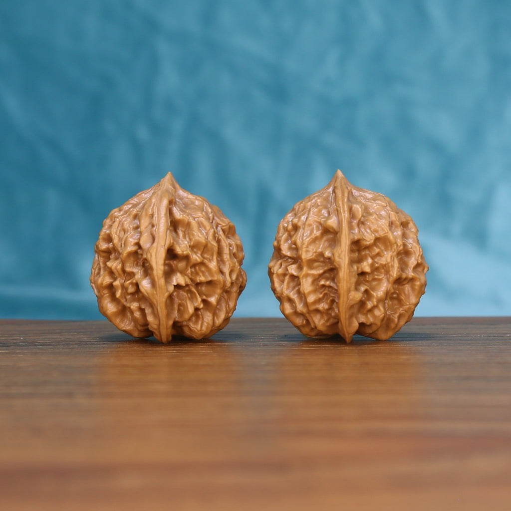 Side view of a Linglong Wenwan walnut pair with detailed natural ridges
