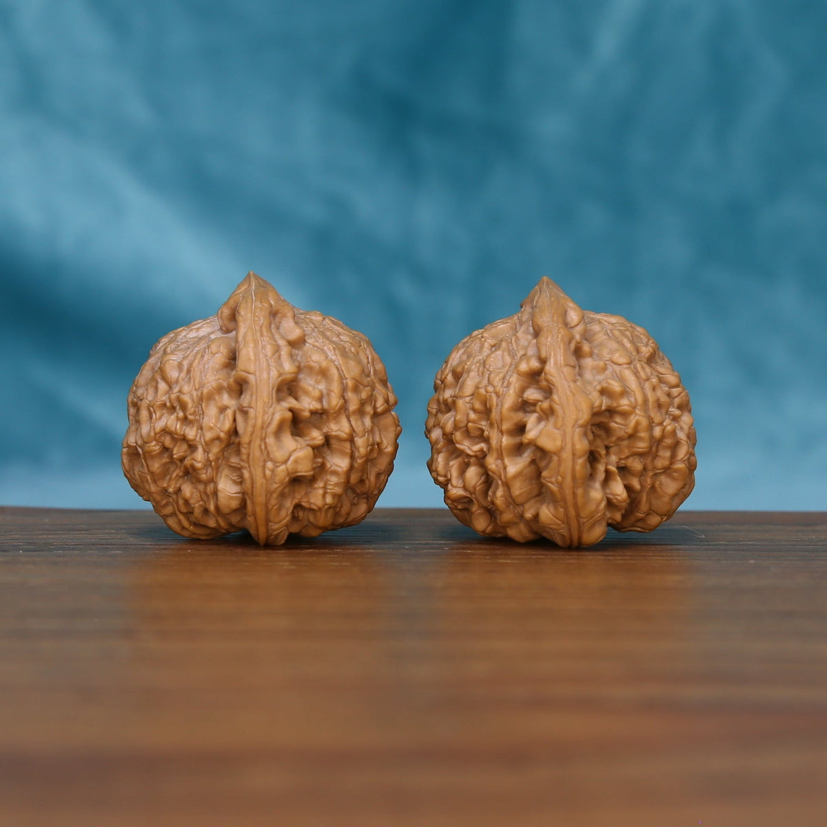 Rear view of The Ember Pair Wenwan Walnut Set displaying the walnuts’ rounded surfaces and deep natural texture.
