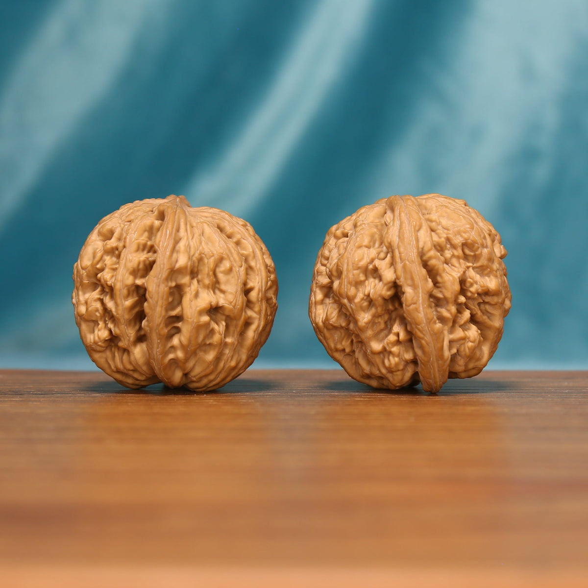 Detailed side view of The Twin Peaks Wenwan Walnut Set with layered sculptural ridge patterns.
