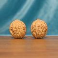 Front view of The Pocket Pebbles Wenwan Walnut Set with two compact rounded walnuts and detailed natural ridges.

