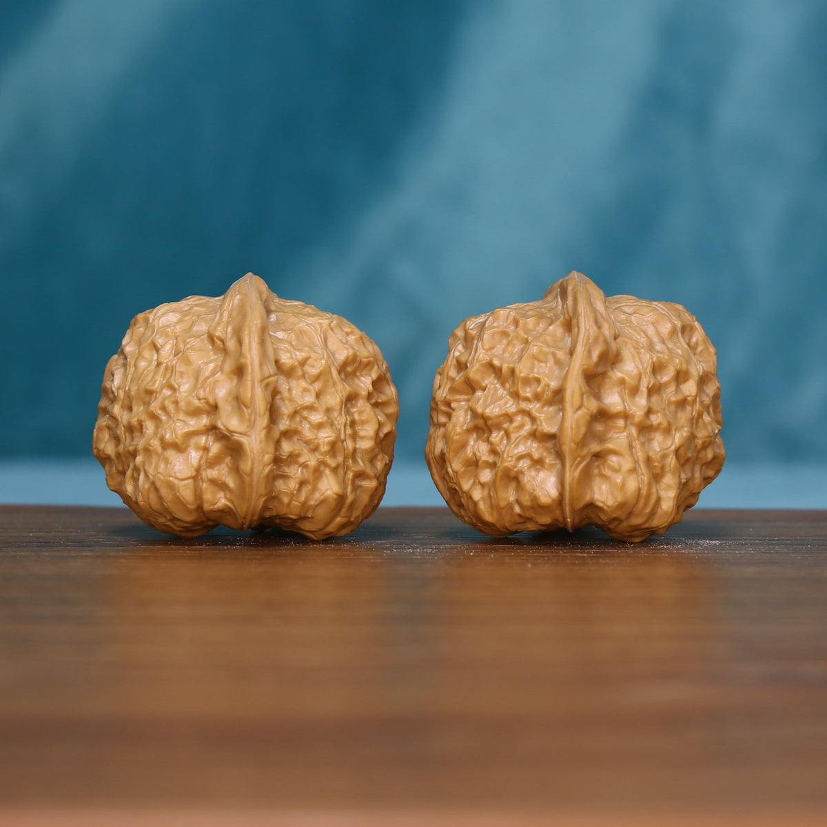 Front view of two 6094 wenwan walnuts with prominent central ridges
