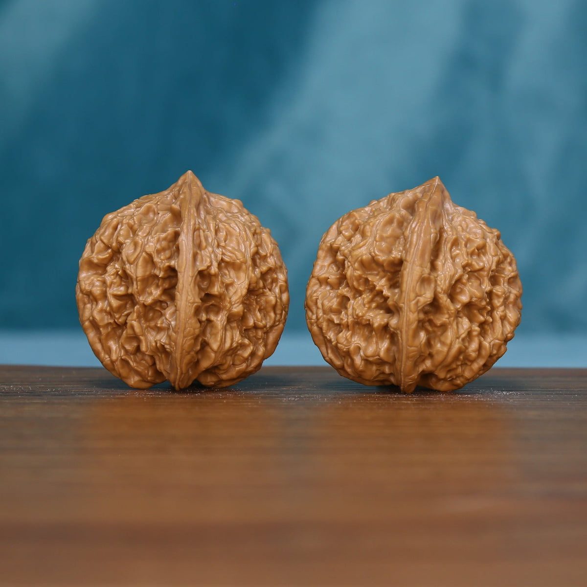 Front view of two 6136 Winding Crown wenwan walnuts with prominent ridges

