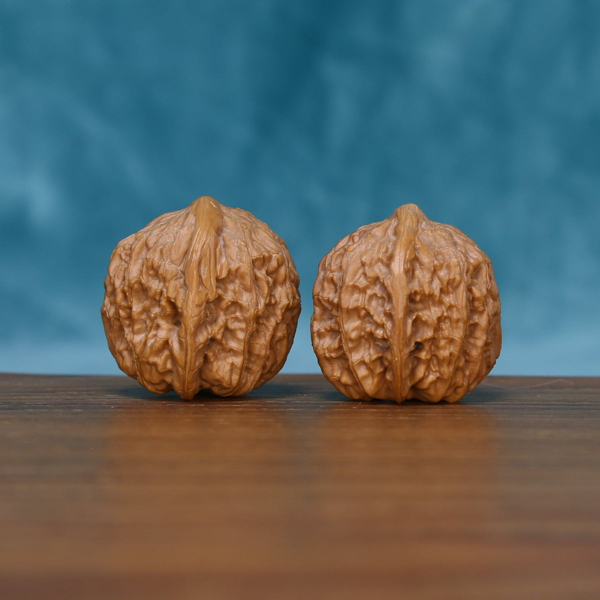 Rear view of The Stone Pearls Wenwan Walnut Set displaying the walnuts’ sculpted surfaces and compact bases.
