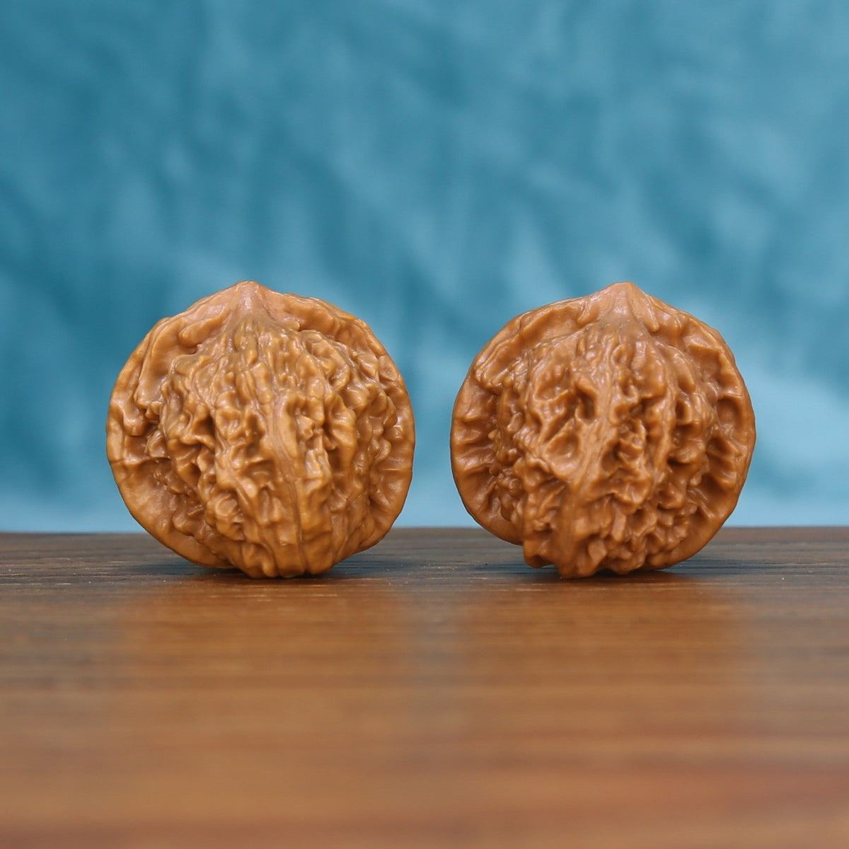 Front view of a matched pair of Qinhuangdao Yuanbao Wenwan walnuts with natural shell texture
