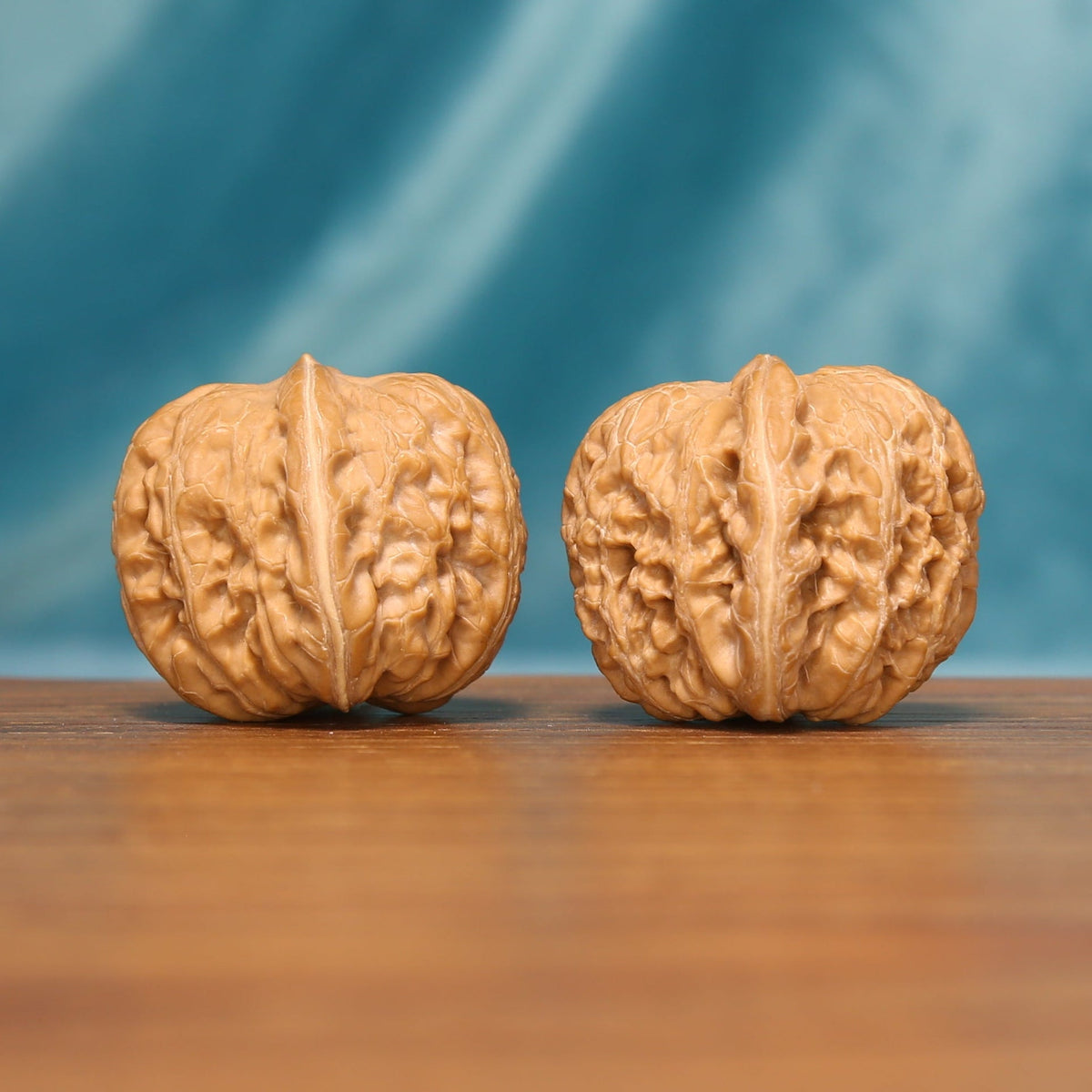 L16 Wenwan walnuts shown side by side from another angle, highlighting their natural grooves and individual texture.
