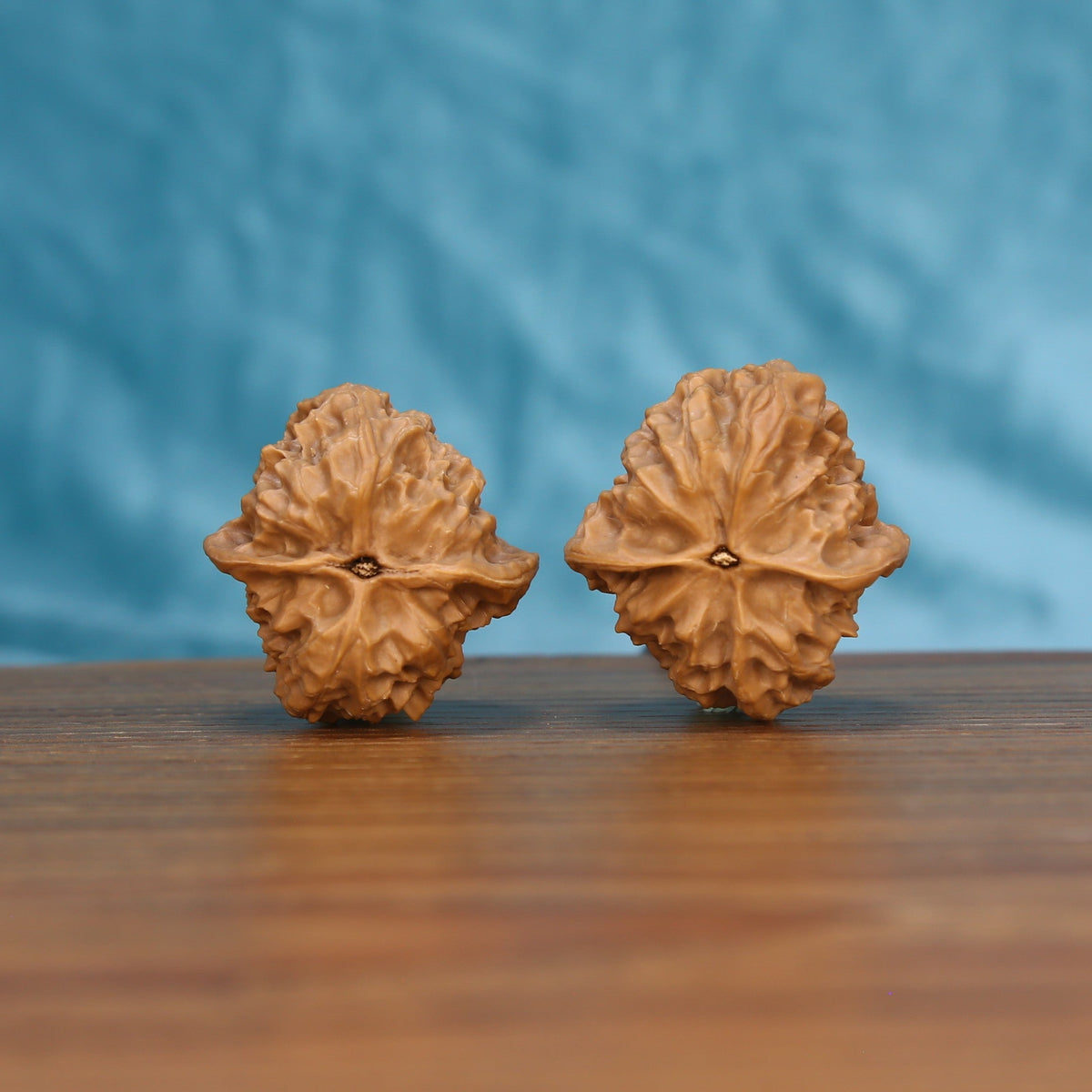Ling-Long walnut pair bottom view on wood – natural hollow-carved base pattern, Exquisite Enigma premium set