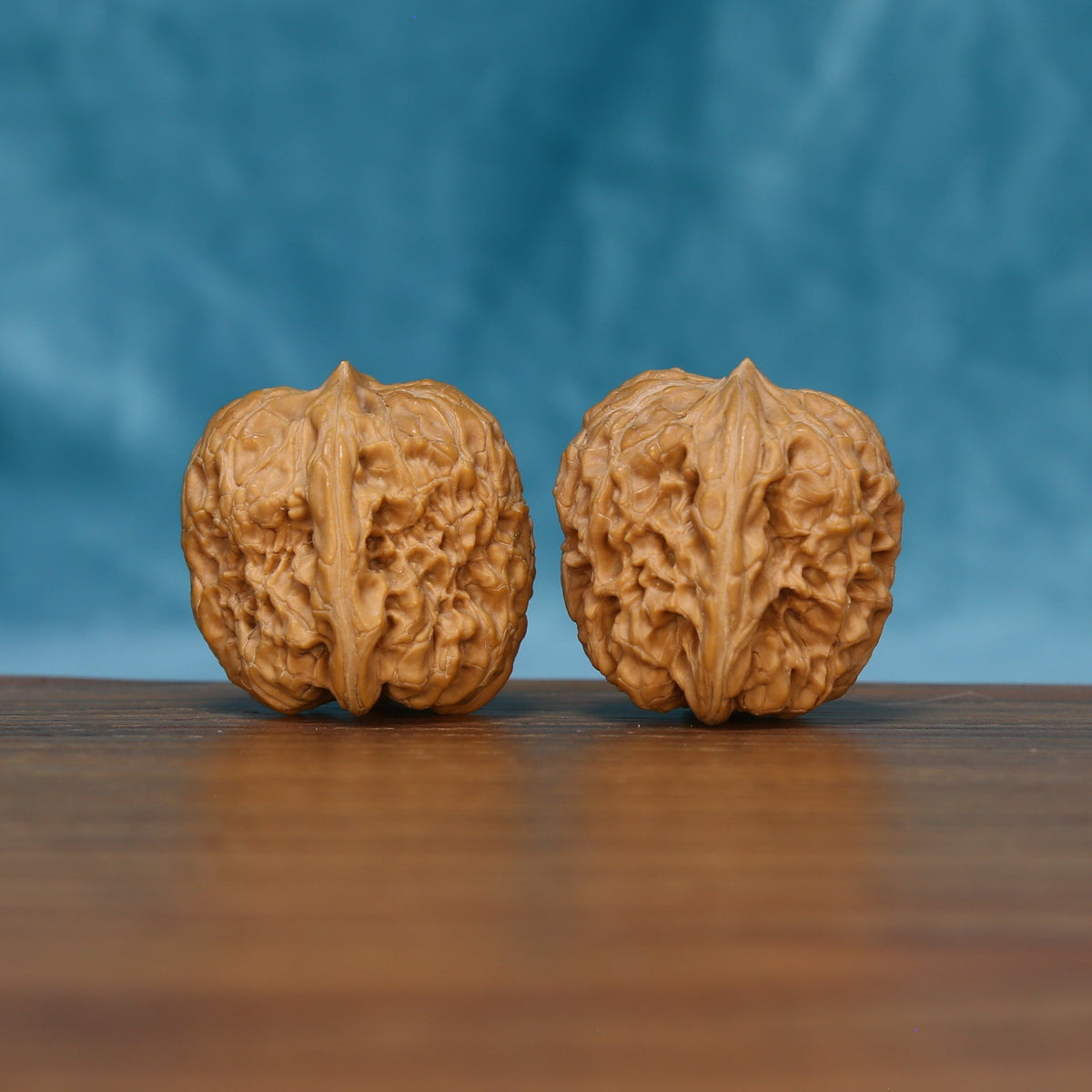 Rear view of The Sandstone Pair Wenwan Walnut Set displaying the walnuts’ sculpted surfaces and rounded bases.
