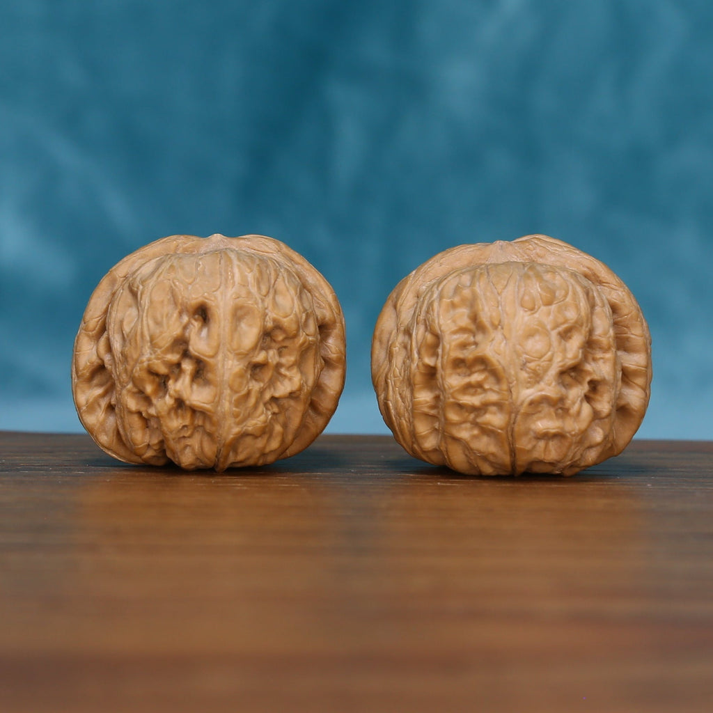 L15 Wenwan Walnut Pair – Front view showing smooth rounded form with wide, flowing grain texture against blue background
