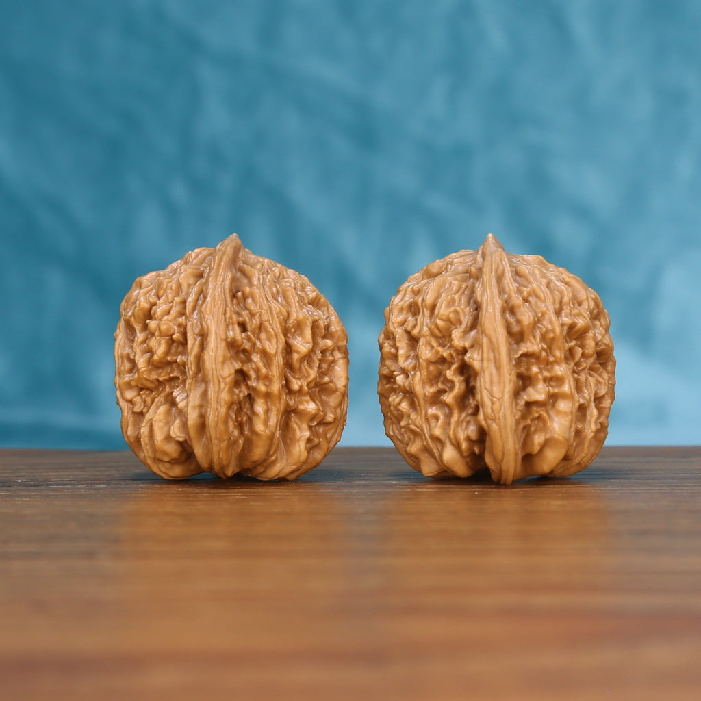 Front view of a matched pair of Sizuo Lou Wenwan walnuts with bold natural ridges

