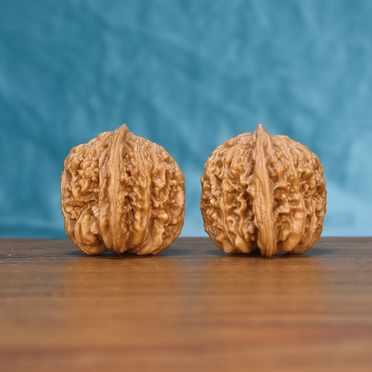 Front view of a matched pair of Sizuo Lou Wenwan walnuts with bold natural ridges
