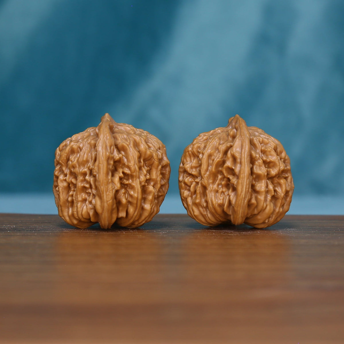 Front view of two 6123 wenwan walnuts showing pronounced central ridges
