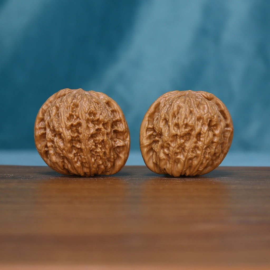 Pair of 6111 Rugged Crest wenwan walnuts with raised rugged grooves
