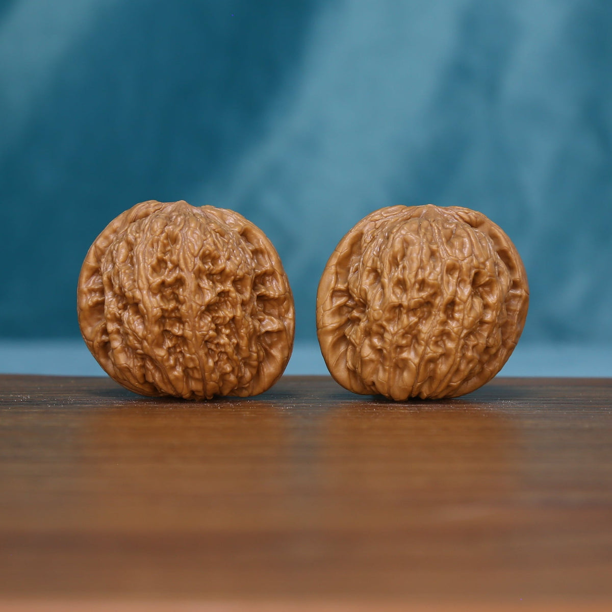 Pair of 6111 Rugged Crest wenwan walnuts with raised rugged grooves
