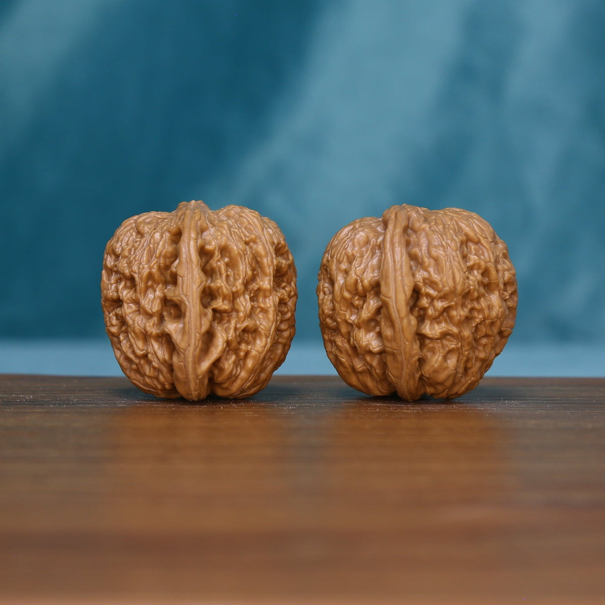Front view of two 6111 wenwan walnuts with prominent central ridges
