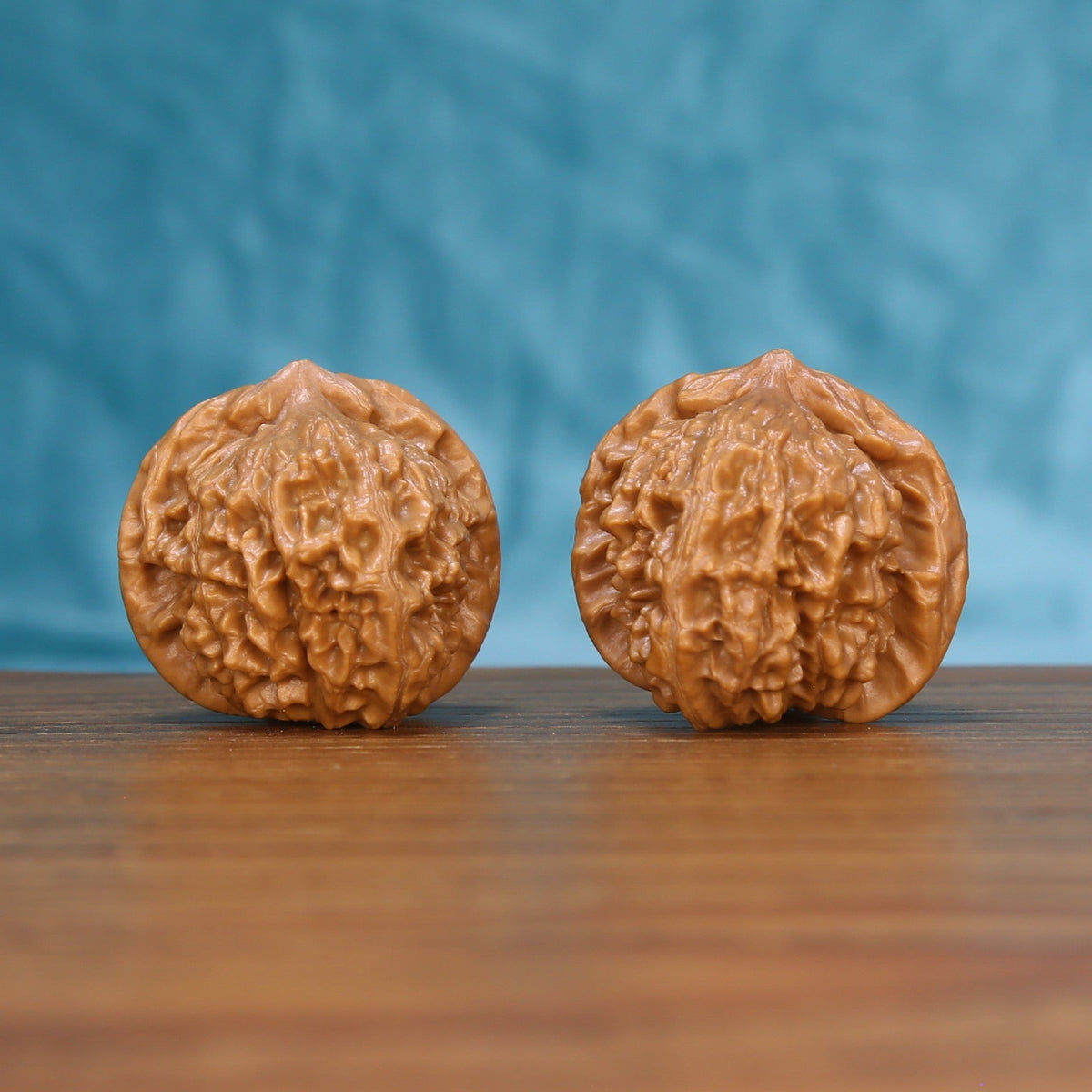 Front view of a matched pair of Qinhuangdao Yuanbao Wenwan walnuts with natural shell texture
