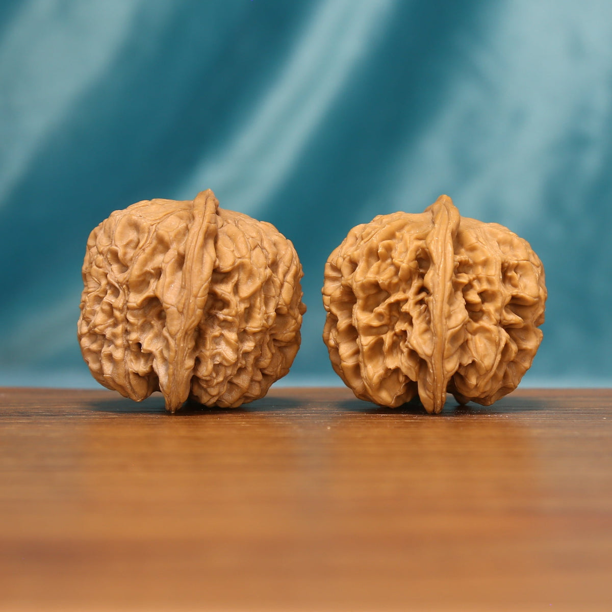 L19 Wenwan walnuts shown side by side from another angle, highlighting their natural grooves and sculpted surfaces.
