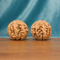 Front view of The Carved Twins Wenwan Walnut Set showing two large rounded walnuts with deeply carved natural ridges.

