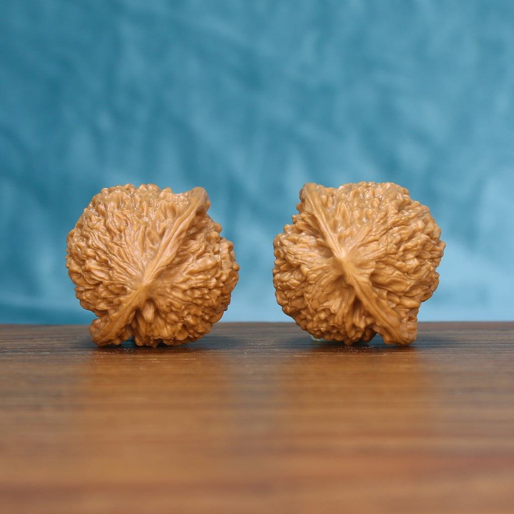 Side profile of the 6204 Little Golden Ox wenwan walnut pair showing the upright silhouette
