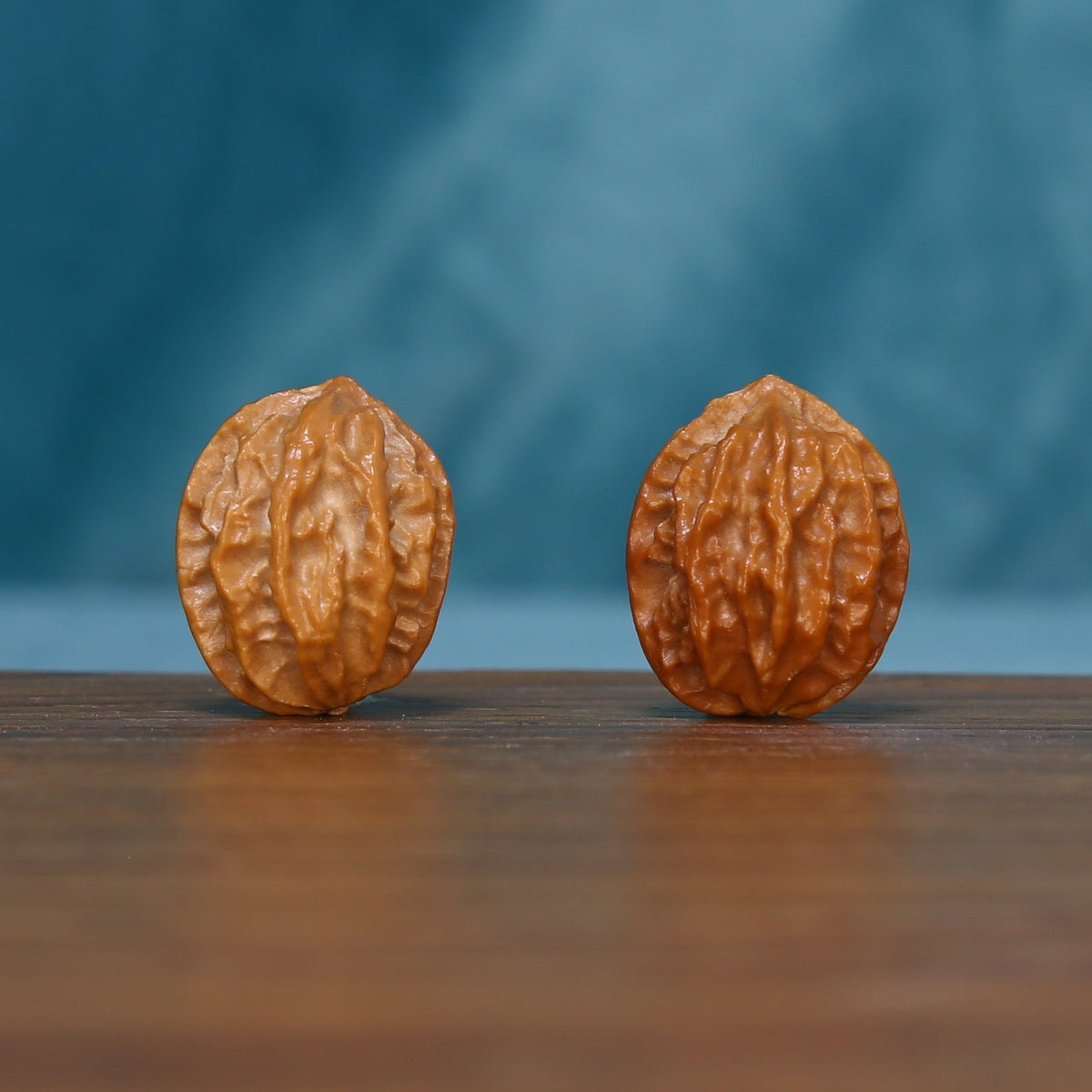Pair of L43 Autumn Ridge wenwan walnuts standing upright with pronounced lengthwise ridges
