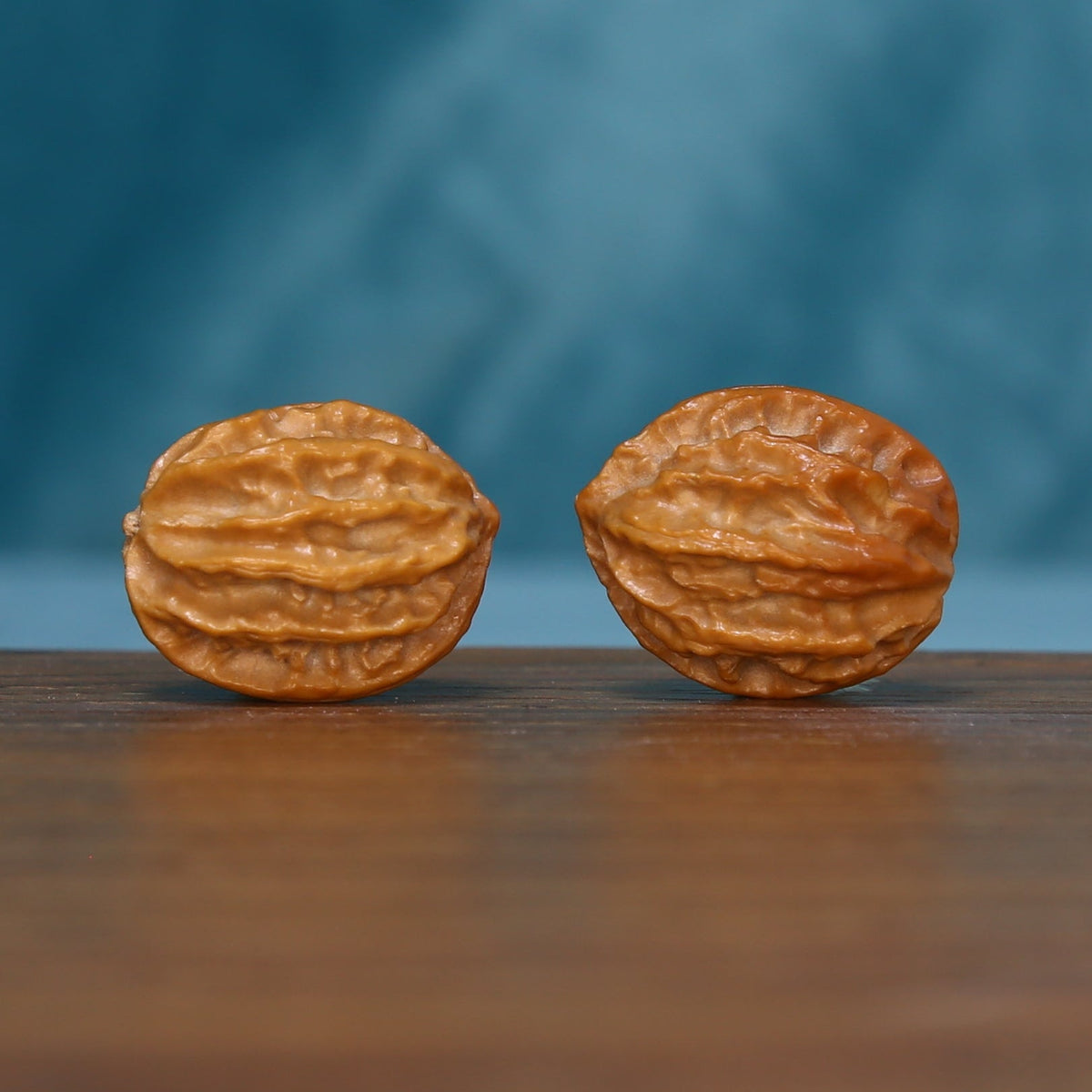 L43 Autumn Ridge wenwan walnut pair laid on their sides, showing layered grooves
