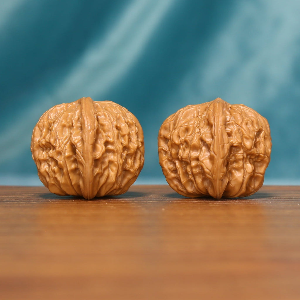 L17 Wenwan walnuts shown side by side from another angle, highlighting their natural grooves and individual texture.

