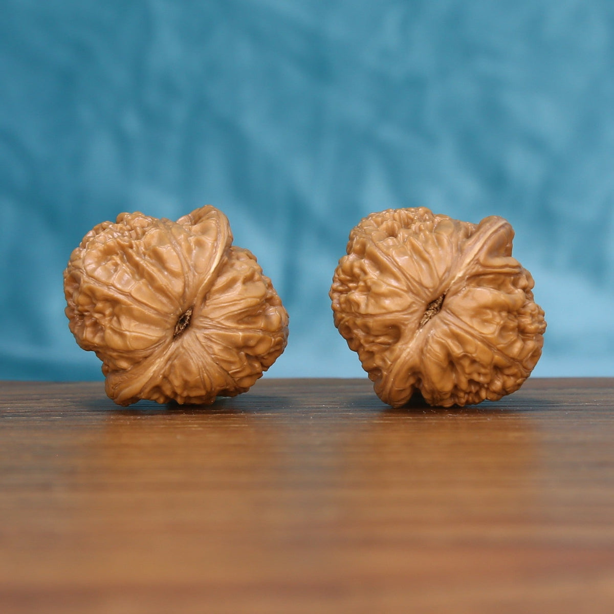 Top view of the Pinggu Ingot wenwan walnut pair 6143, showing the star-shaped ridged crown of each walnut

