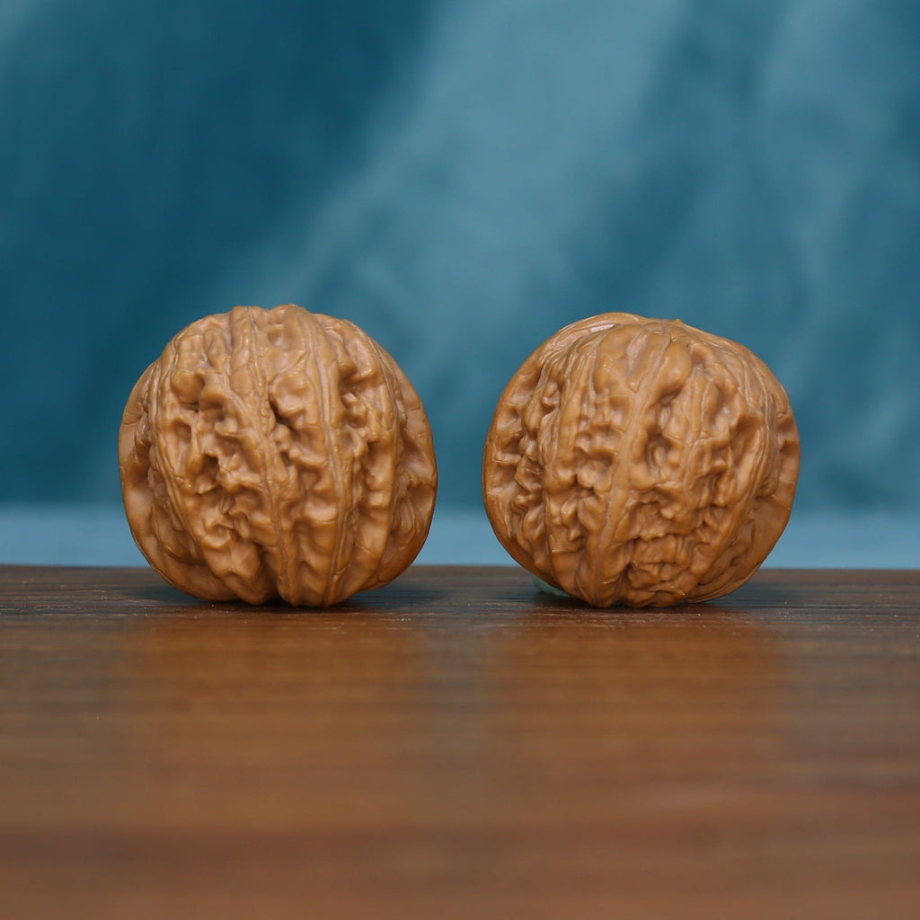 Reverse view of the L42 wenwan walnut pair showing deeply textured surfaces
