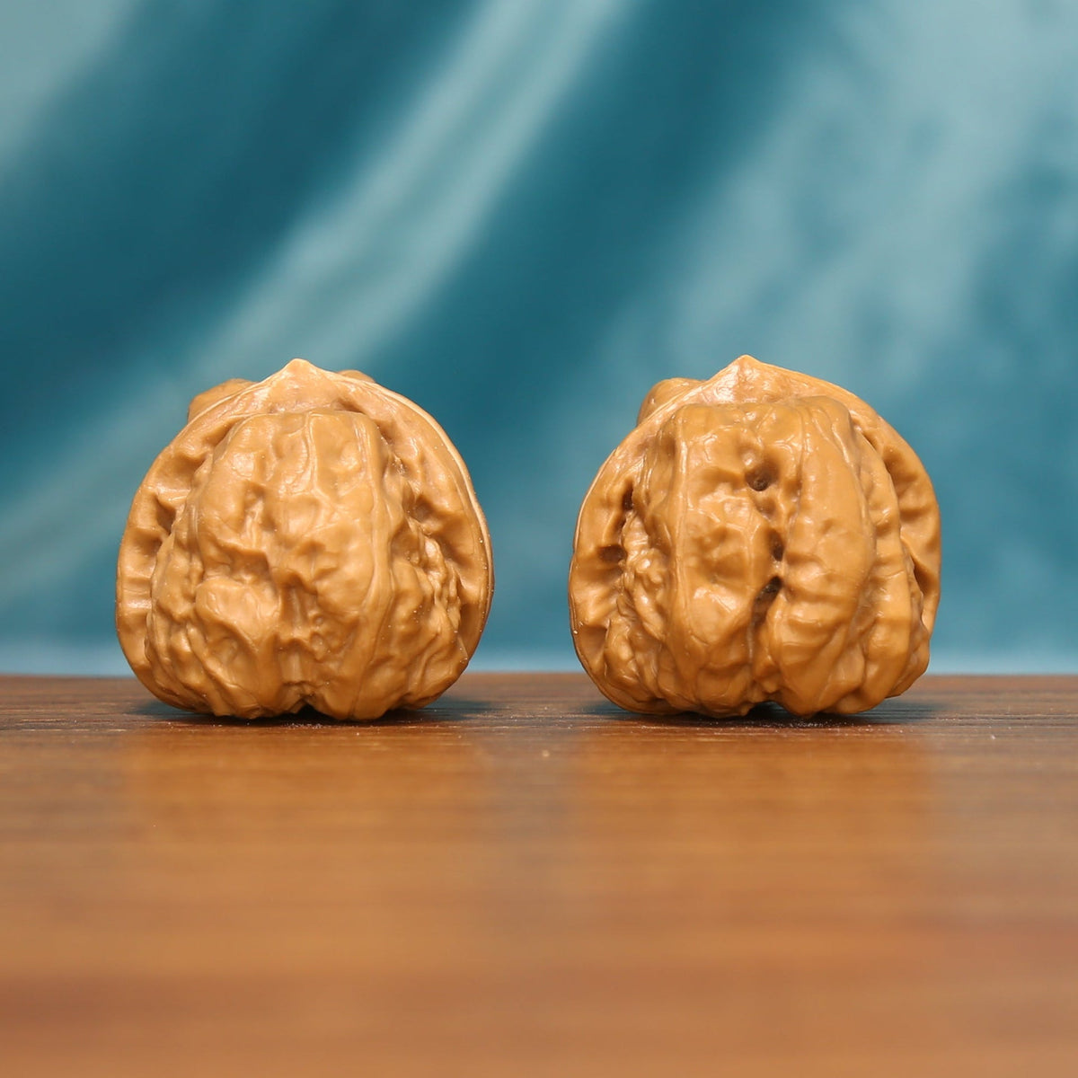 Front view of The Ridge Lanterns Wenwan Walnut Set showing two deeply textured walnuts with bold natural ridges.
