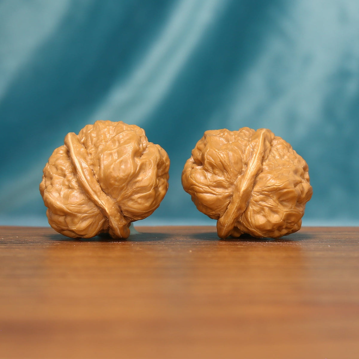 Side view of The Ridge Lanterns Wenwan Walnut Set showing the walnuts’ textured profiles and natural color.
