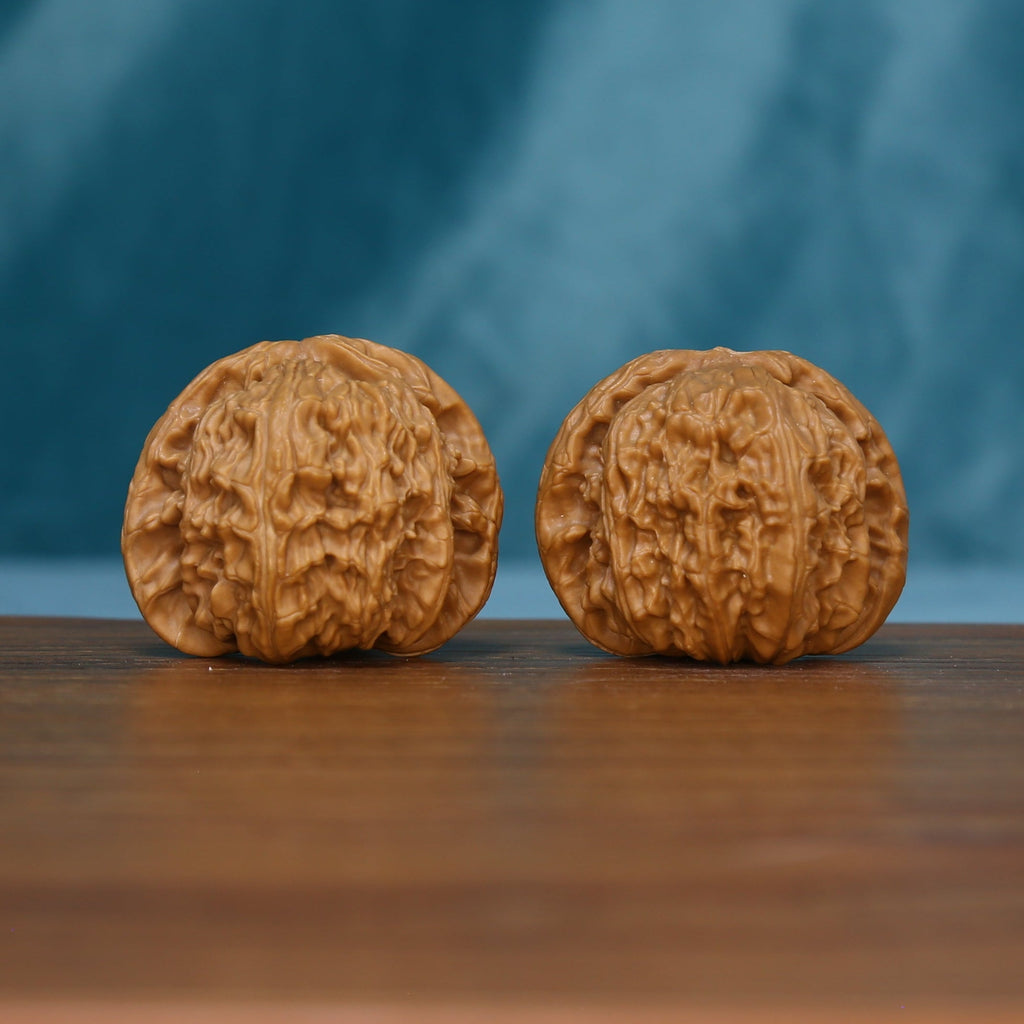 Pair of S45 White Lion wenwan walnuts with deep grooves and raised tan ridges
