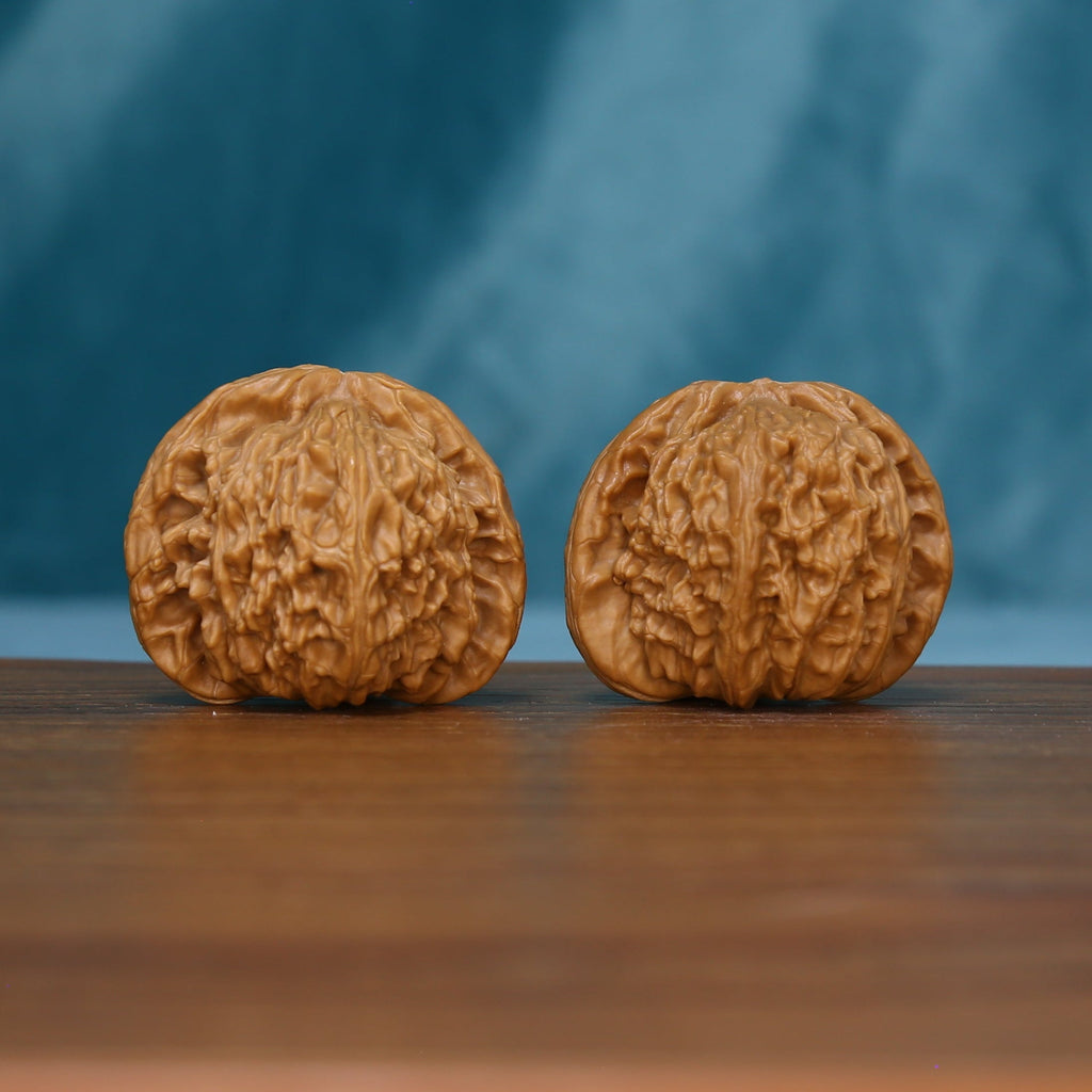 S45 White Lion wenwan walnut pair showing their rounded shapes and textured surfaces
