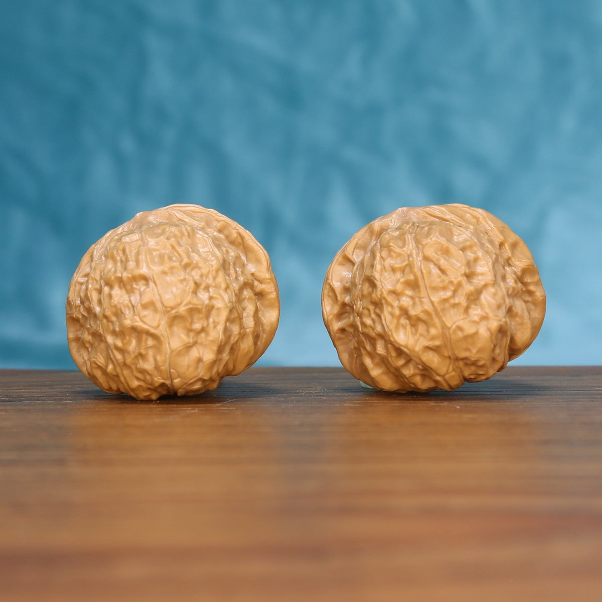 Pumpkin wenwan walnut pair 6211 shown side by side, front view of the squat rounded form
