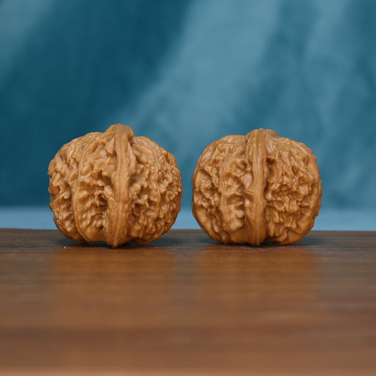 Another view of two S45 White Lion wenwan walnuts with branching grooves
