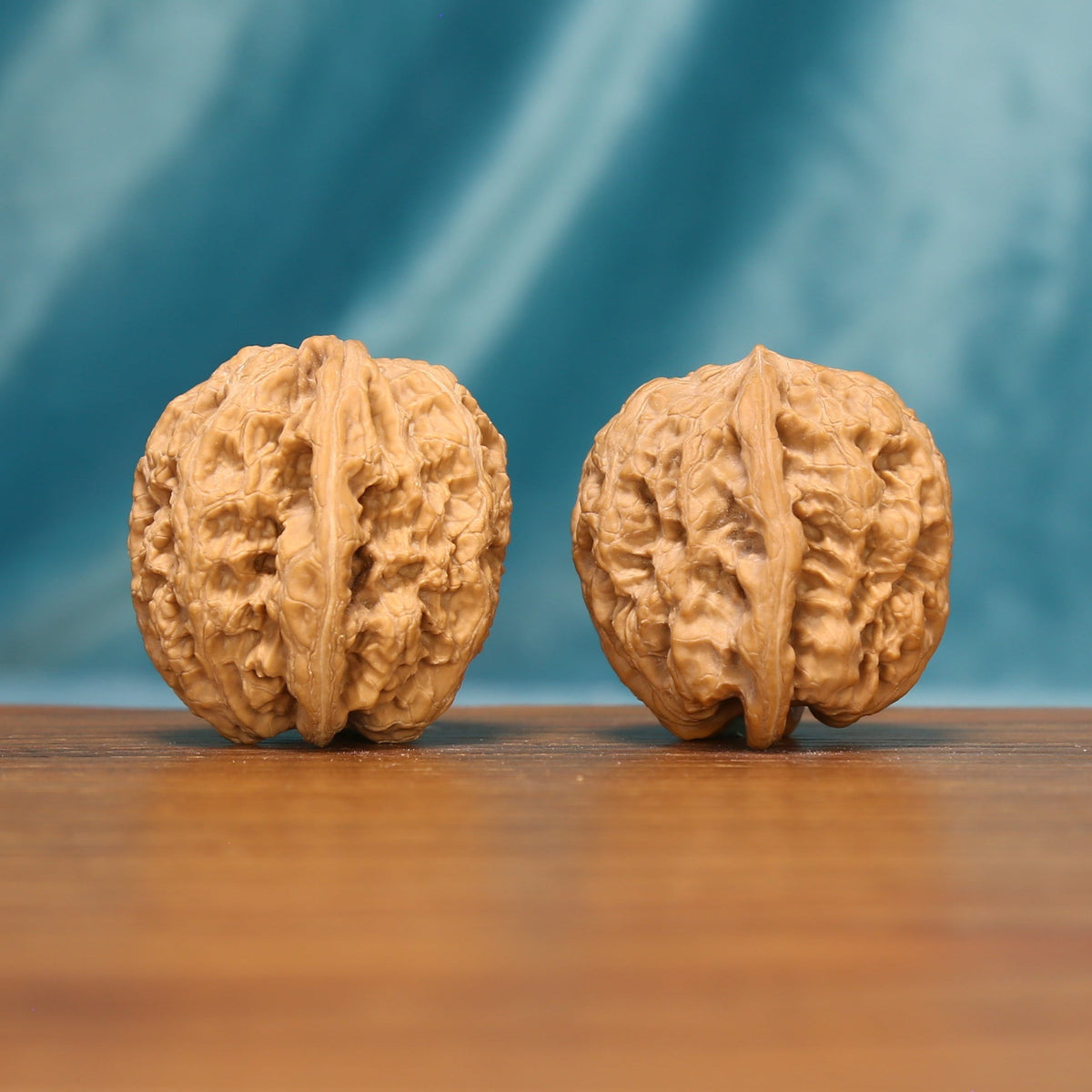 Detailed side view of Lion Head Wenwan walnuts highlighting their bold natural texture.
