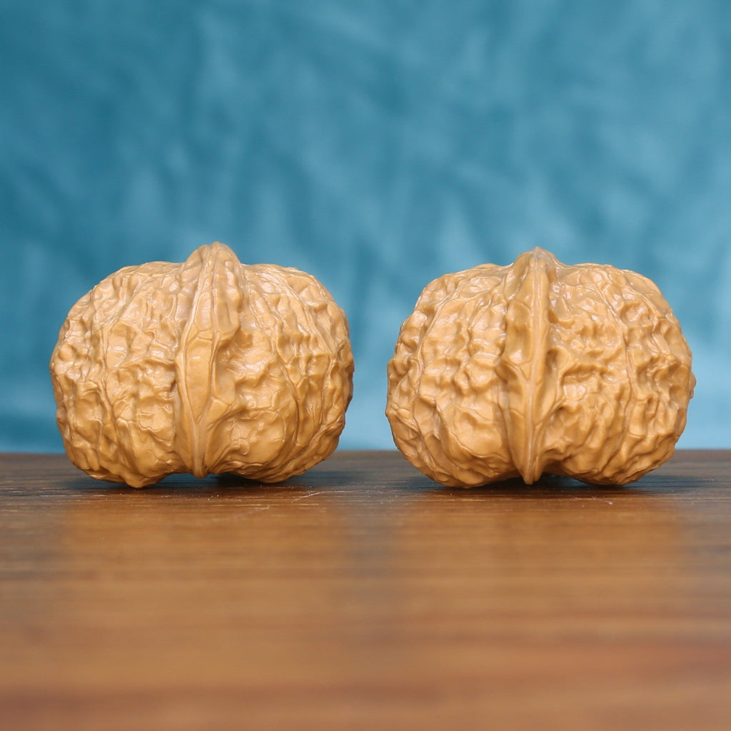 Pumpkin wenwan walnut set seen at a slight angle, highlighting the wide belly and low height
