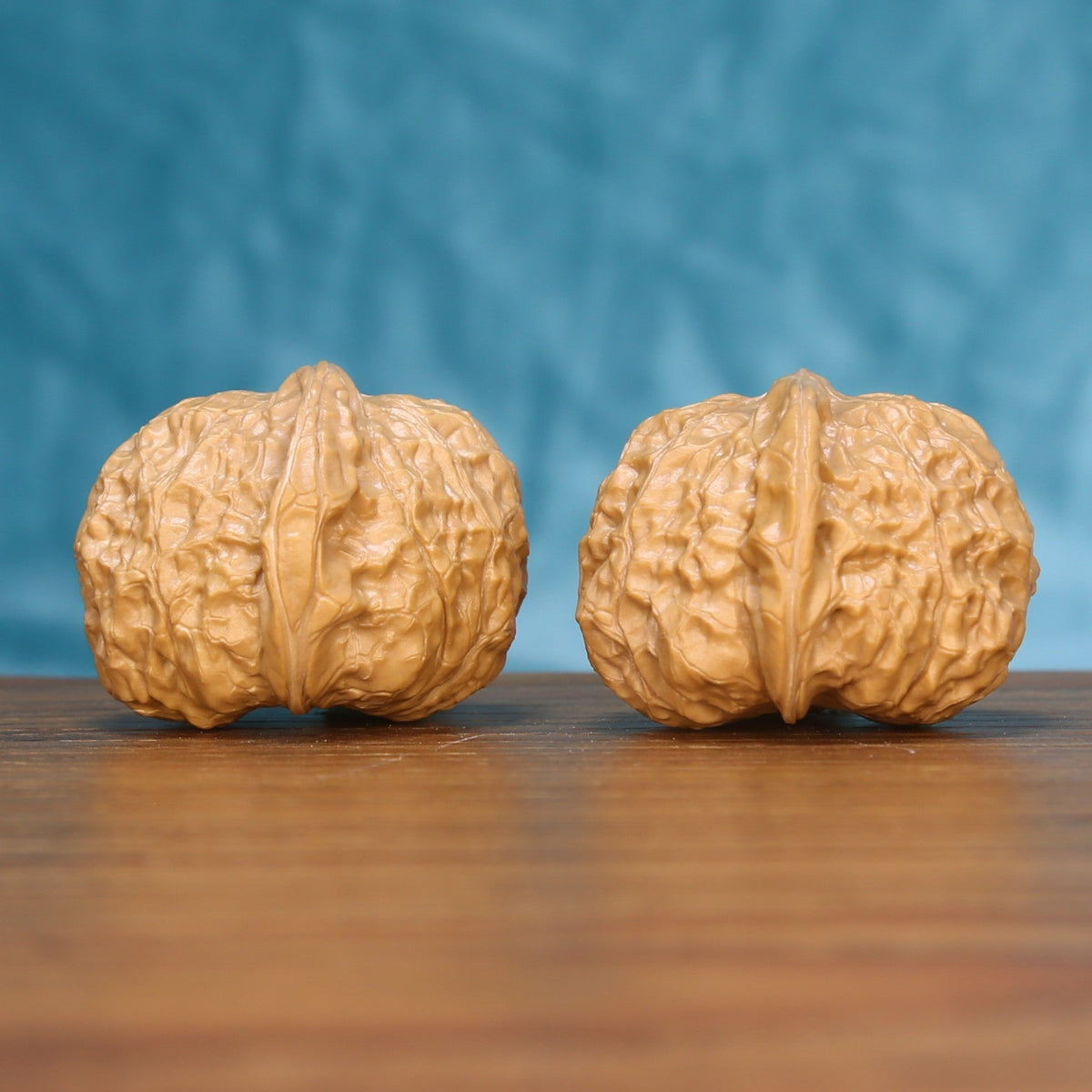 Pumpkin wenwan walnut set seen at a slight angle, highlighting the wide belly and low height
