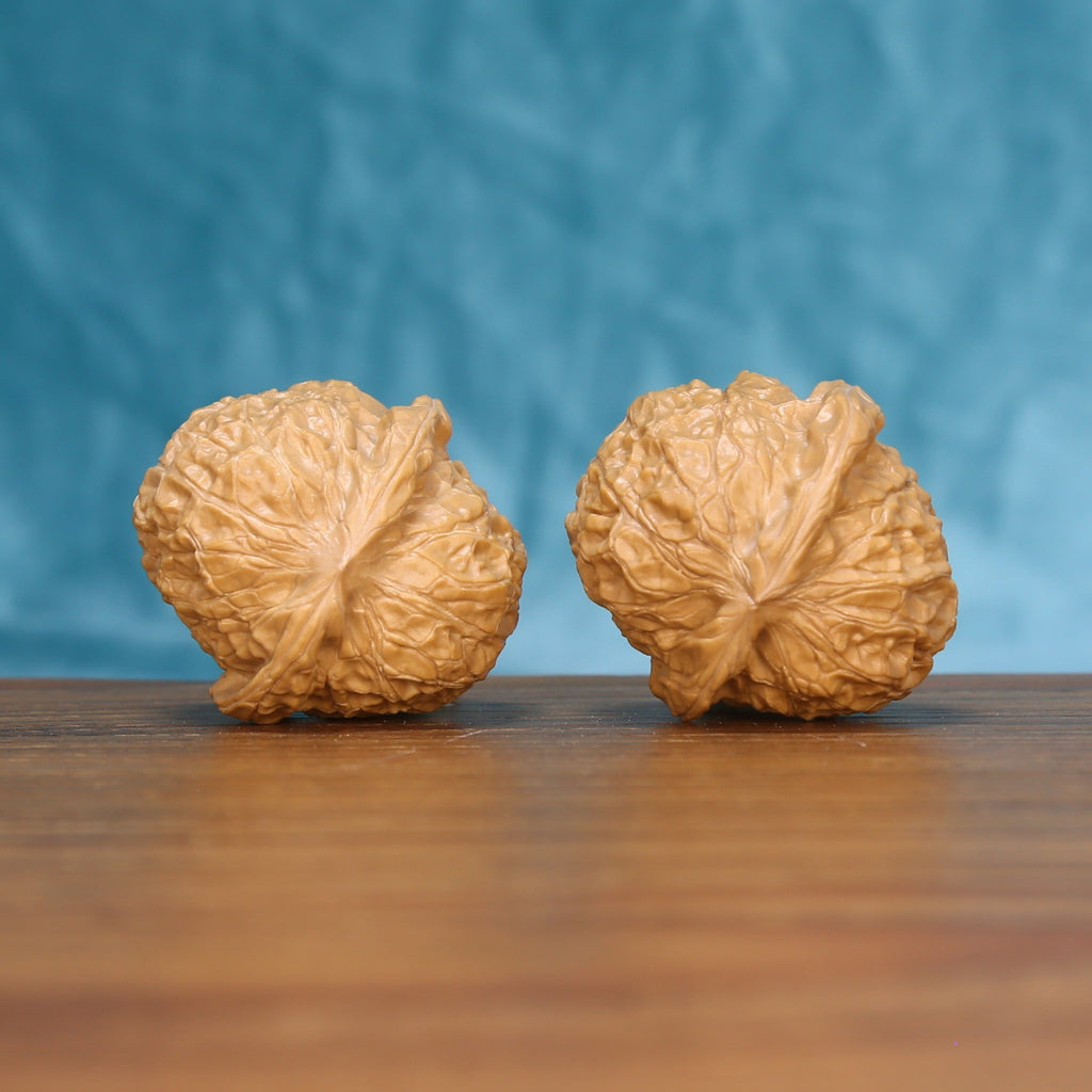 Side profile of the 6211 pumpkin wenwan walnut pair showing the flattened pumpkin silhouette
