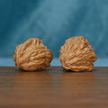 Pair of 1789 wenwan walnuts showing fan-like ridges from an angled view

