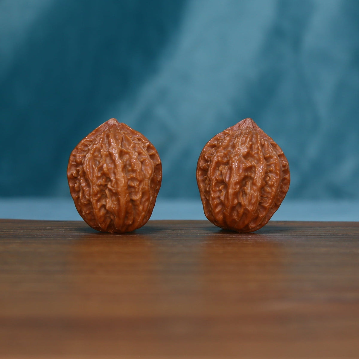 Pair of small 244 wenwan walnuts standing upright with raised grooves
