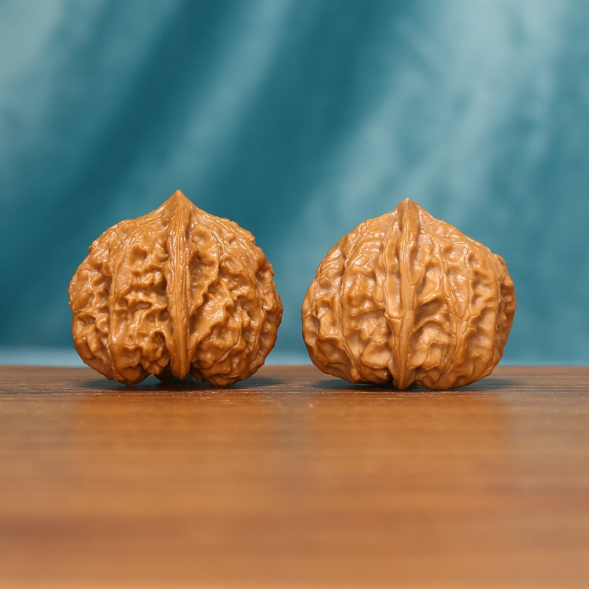Detailed side view of Honeycomb Lion Head Wenwan walnuts highlighting their dense honeycomb-like ridges.
