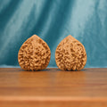 L22 Wenwan walnut matched pair displayed side by side on a wooden surface against a teal background.
