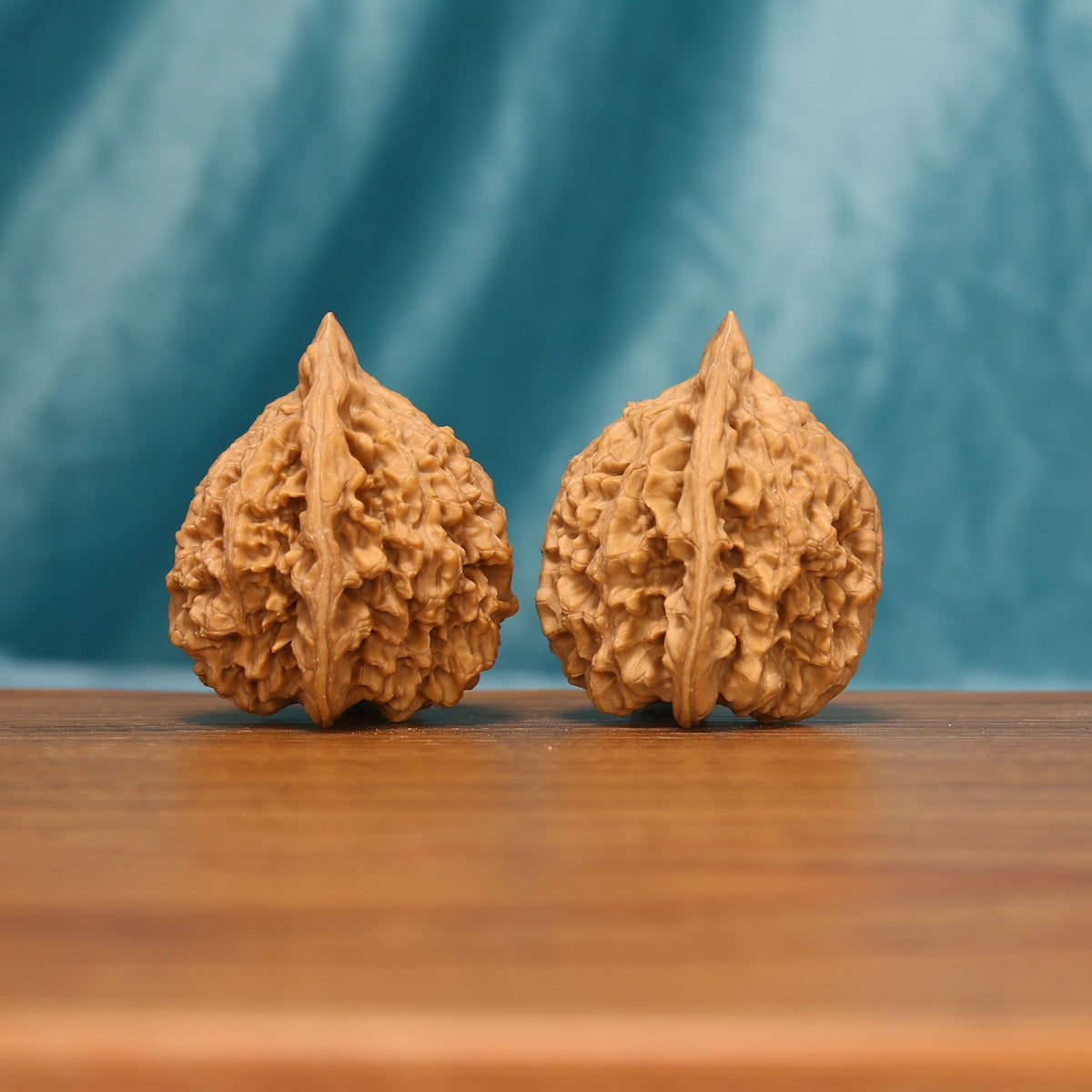 L22 Wenwan walnut matched pair shown from a detailed front angle, displaying tall ridges and textured surfaces.
