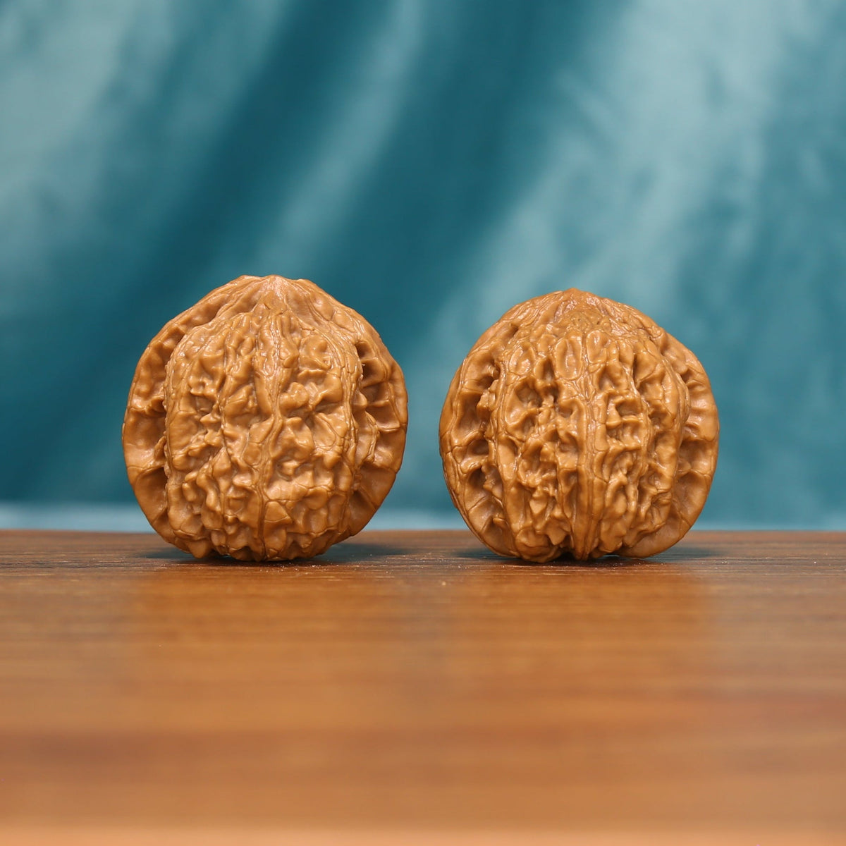 The Emberstone Twins L37 wenwan walnut pair, front view showing deeply weathered texture
